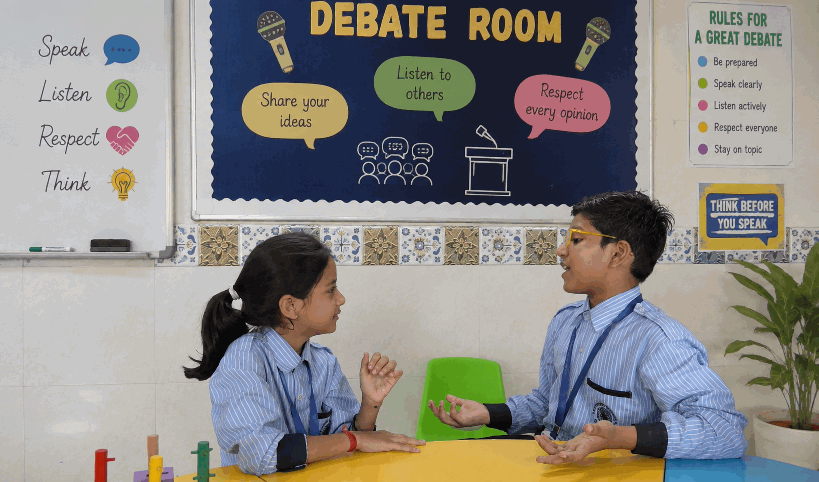Two students in conversation in the school debate room