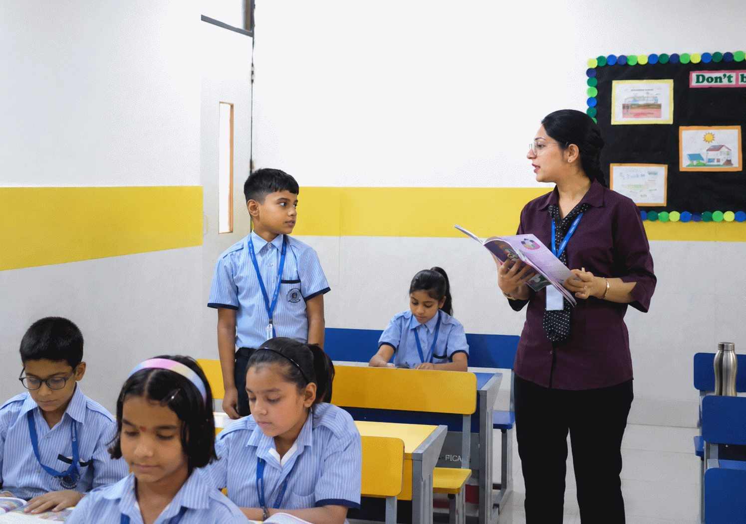 A teacher leading a lesson using a digital classroom screen