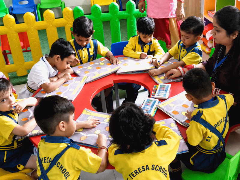 Students seated around a table working on a classroom activity
